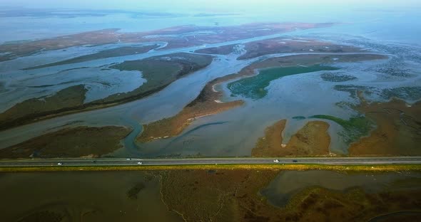 Asphalt Highway with Fast Car Traffic Among Venetian Lagoon