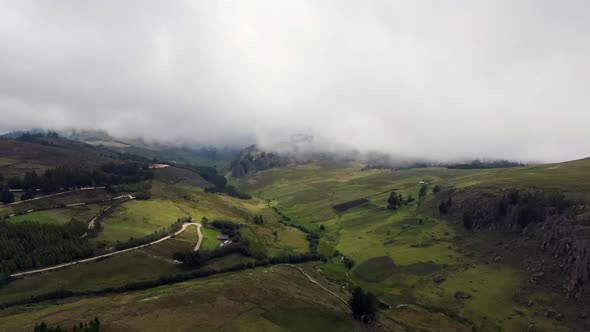 Green Terrain Of The Hills Under White Cloudy Sky In Cumbemayo In Peru. aerial