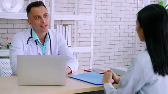 Doctor in Professional Uniform Examining Patient at Hospital