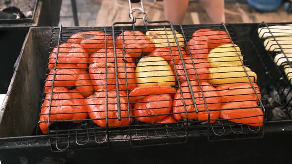 Bell Peppers and Vegetables are Grilled on Grid in Open Barbecue at Food Court