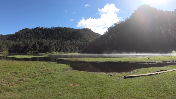 Footage of Zempoala Lake and its mist rising early in the morning in Central Mexico