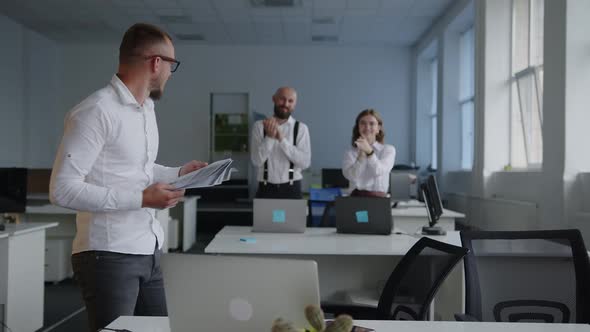 Coworkers Clap Their Hands and Greet the Employee