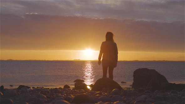 Adventure Caucasian Adult Woman Standing on a Rocky Beach