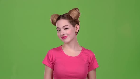 Girl Shows the Heart Shape with Her Hands. Green Screen
