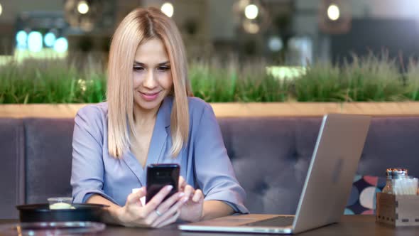 Portrait of Happy Smiling Young Female Businesswoman Typing Message or Chatting Using Smartphone