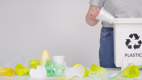 Sorting Plastic Cups And Straws To Container