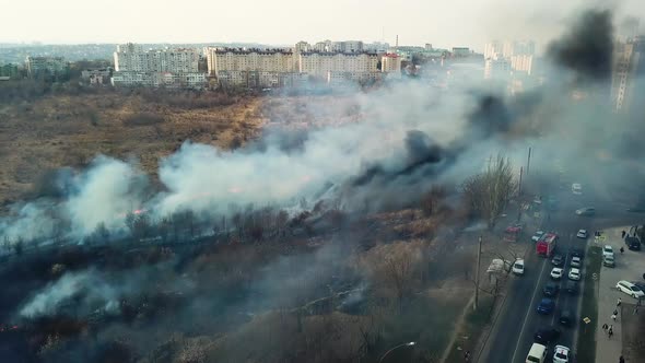 Smoke and Fire Burning Dry Grass on the Hillside