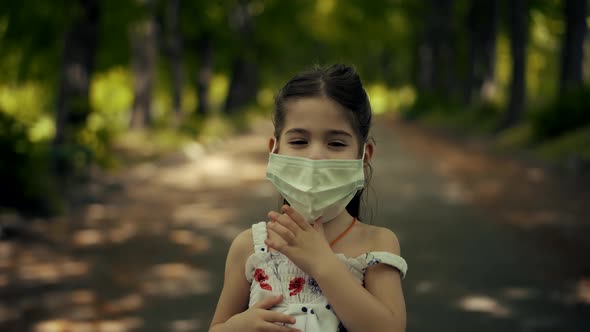 Kid In Face Mask. Epidemic Coronavirus On Nature Outdoors. Children Girl Walking In Face Mask.
