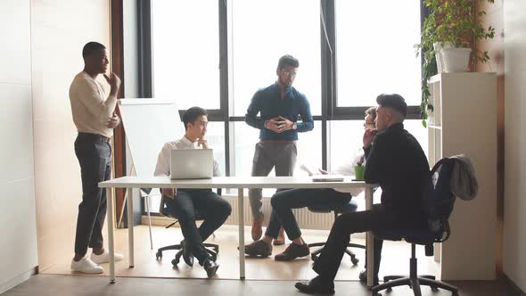 Multiracial Male Staff Communicating in Modern Loft Office