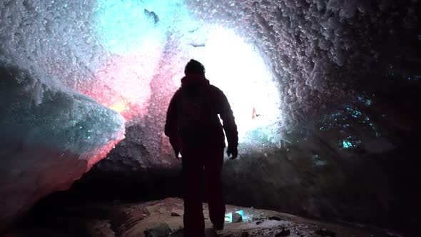 A Guy in an Ice Cave with a Lantern Light