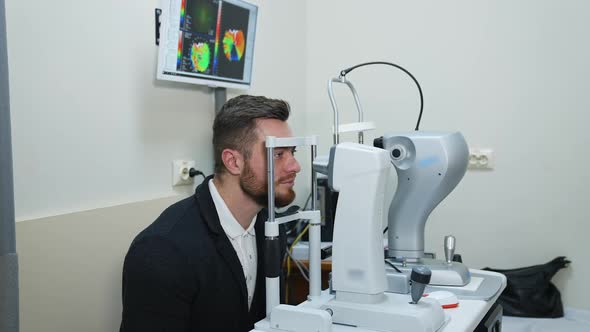 Man looking in apparatus for eyesight.
