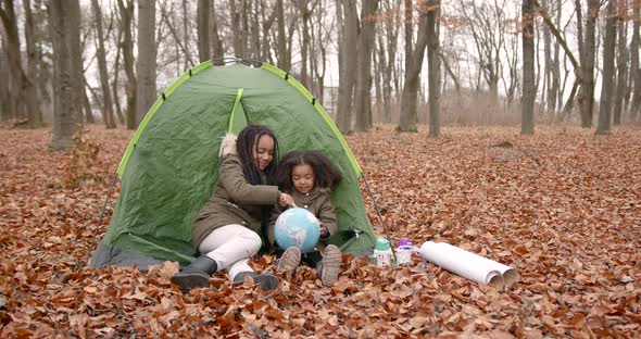 Black Race Kids Holding a Globe in an Autumn Forest