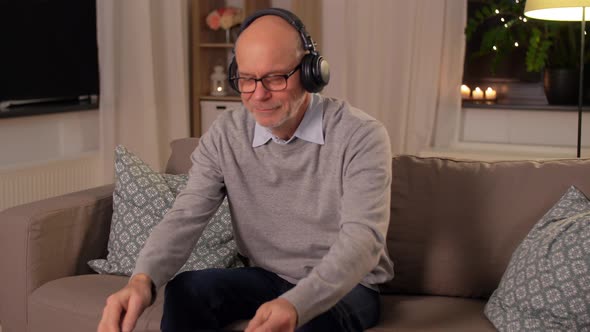 Senior Man with Tablet Pc and Headphones at Home