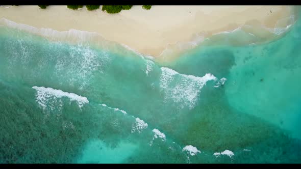 Aerial view scenery of beautiful coastline beach lifestyle by aqua blue ocean with white sandy backg