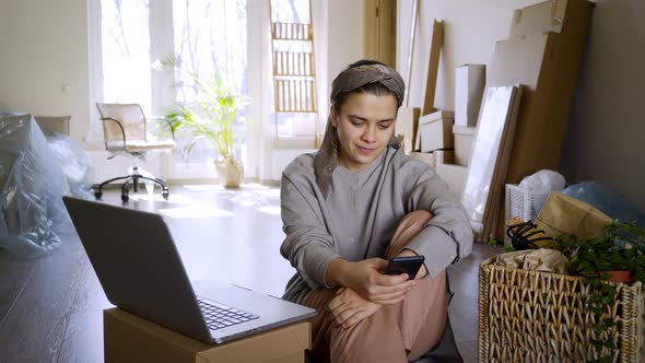 Woman Work on Laptop Among Cardboard Box