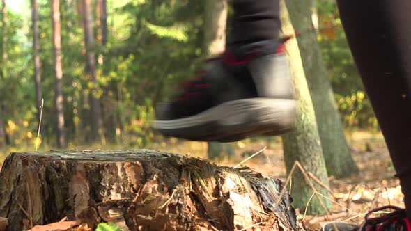 A Woman Steps Onto a Stump, Looks Around, and Walks on - Closeup on the Stump