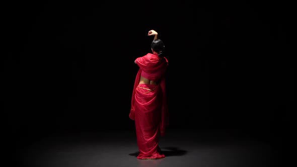 Woman Starts Dancing Belly Dance in Dark Studio, Slow Motion.