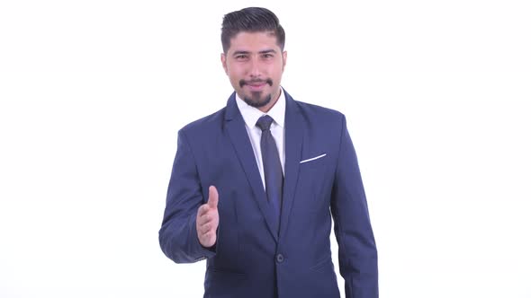 Happy Bearded Persian Businessman Giving Handshake