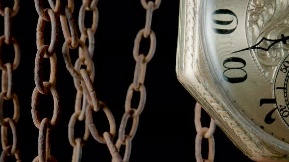 Antique Gold Pocket Watch Hanging From a Rough Rusty Chain