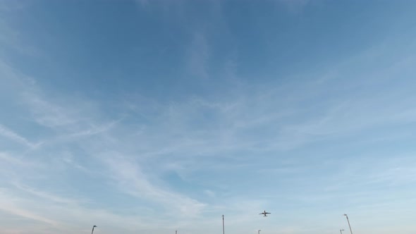 Static view of airplane taking off towards the sun from the Hong Kong International Airport.