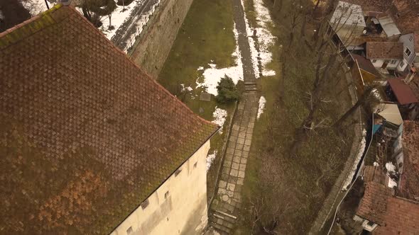 Flying over the surroundings of the fortress of the city of Sighisoara on winter time. Transylvania