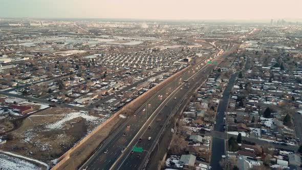 HIghway traffic of I25 highway with the downtown Denver skyline in the very far background.