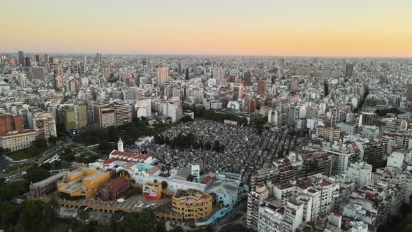 Aerial establishing shot of La Recoleta Cemetery in downtown Buenos Aires at sunset