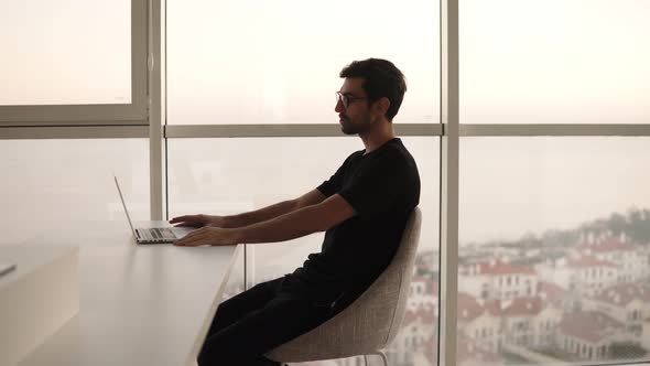 Relaxed Caucasian Man in Stylish Glasses Using Laptop Having Video Call