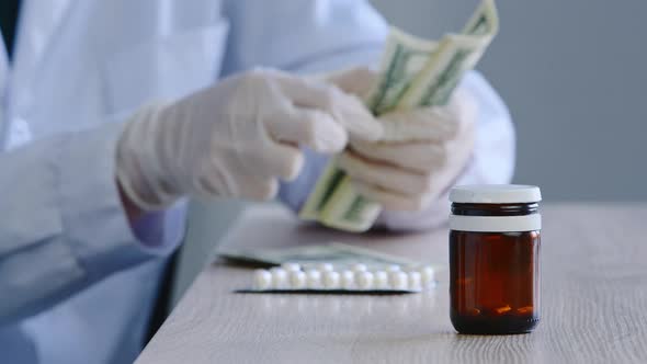 Closeup Female Hands in White Latex Gloves Pharmacist Doctor Scientist in Medical Coat Sits at Table