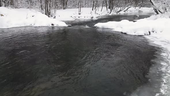 Christmas Snowy Beautiful Landscape with Icefree River Aerial View