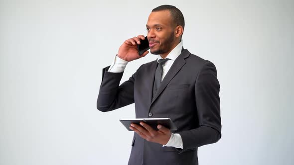 Professional African-american Business Man Holding Tablet Pc and Talking on the Phone