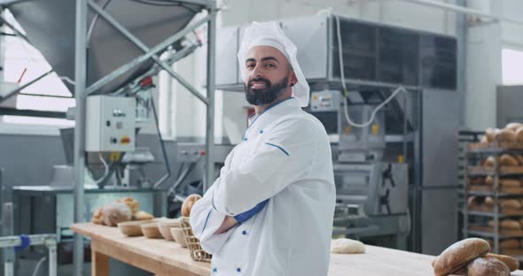 Attractive Man Baker in a Stylish Uniform Smiling