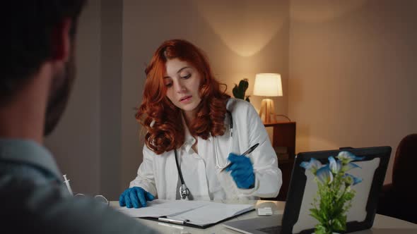 Italian Female Doctor and Patient Behind Anonymous Man in Private Clinic