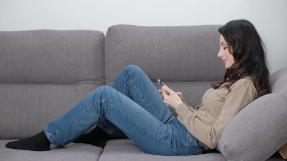 Woman using smart phone to browse news feed on internet