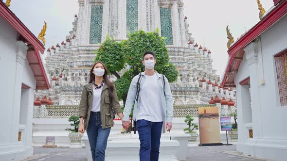 Asian romantic couple wear mask, travel in the city for honeymoon trip.