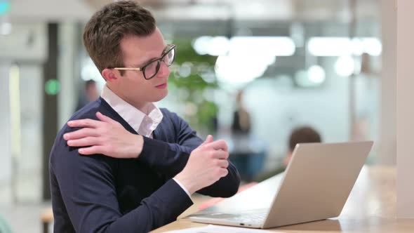 Exhausted Young Businessman with Laptop Having Back Pain 