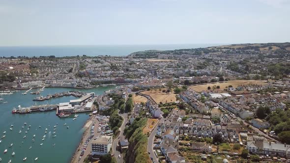 Wide aerial shot of the town of Brixham and harbour. Devon county, England, UK.