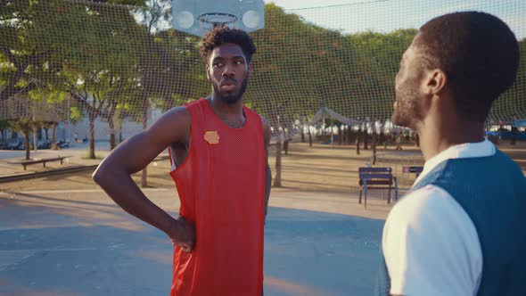 Cinematic footage of a street basketball game outdoor.