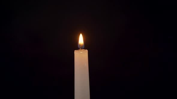 Closeup of an Isolated Burning Candle on a Black Background