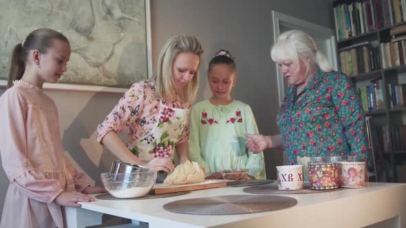 Portrait of Happy Three Female Generations Talk During Kneading Dough