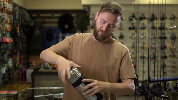 Bearded Man in a Fishing Tackle Shop Getting Ready for a Fishing Trip