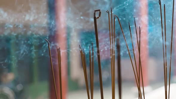 Close-up of incense sticks burning with smoke in buddhist temple of Ho Chi Min City, Vietnam