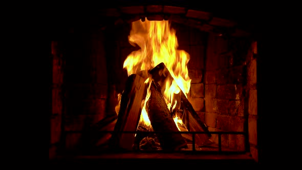 Glowing fire in home stone fireplace