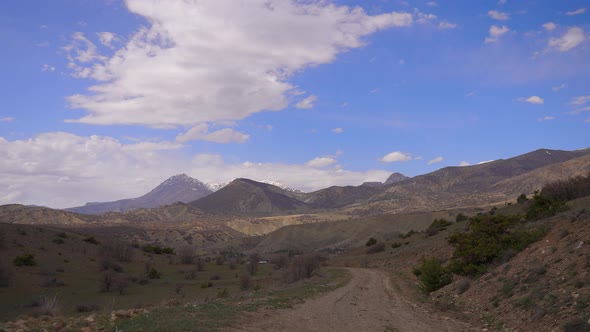 Time lapse of cloud shadows as low cloudse over mountainous terrain