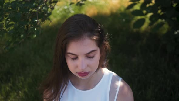 Portrait of Beautiful Brunette Student Woman Outdoor in the Summer, Looking and Smiling Close-up