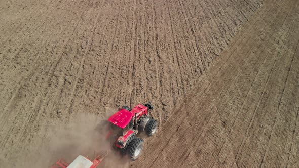 Tractor Cultivating Dusty Arid Farmland