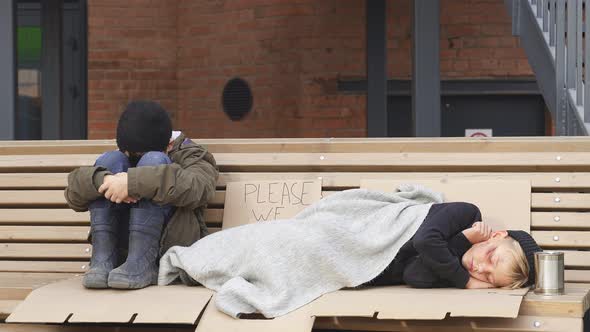 Two Desperate Street Children Asking for Help in Dirty Town on Street