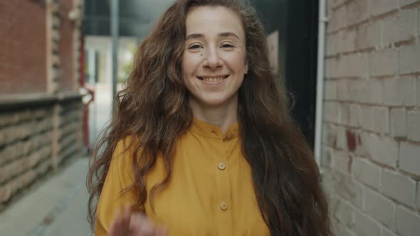 Slow Motion of Happy Young Woman Showing Ok Hand Gesture and Smiling Outdoors in City Street