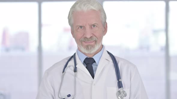 Portrait of Smiling Old Senior Doctor Looking at the Camera 