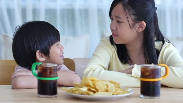 Asian Children Eating Snack Together